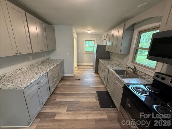 a kitchen with stainless steel appliances granite countertop a stove and a sink
