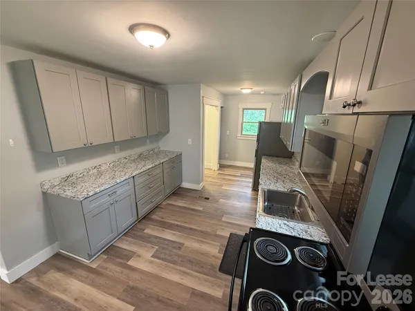 a kitchen with refrigerator and window