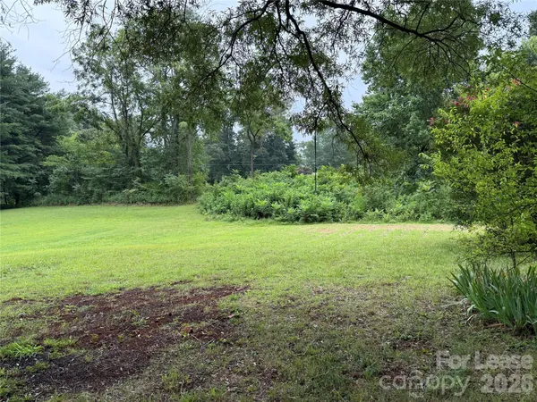 a view of a field with an trees