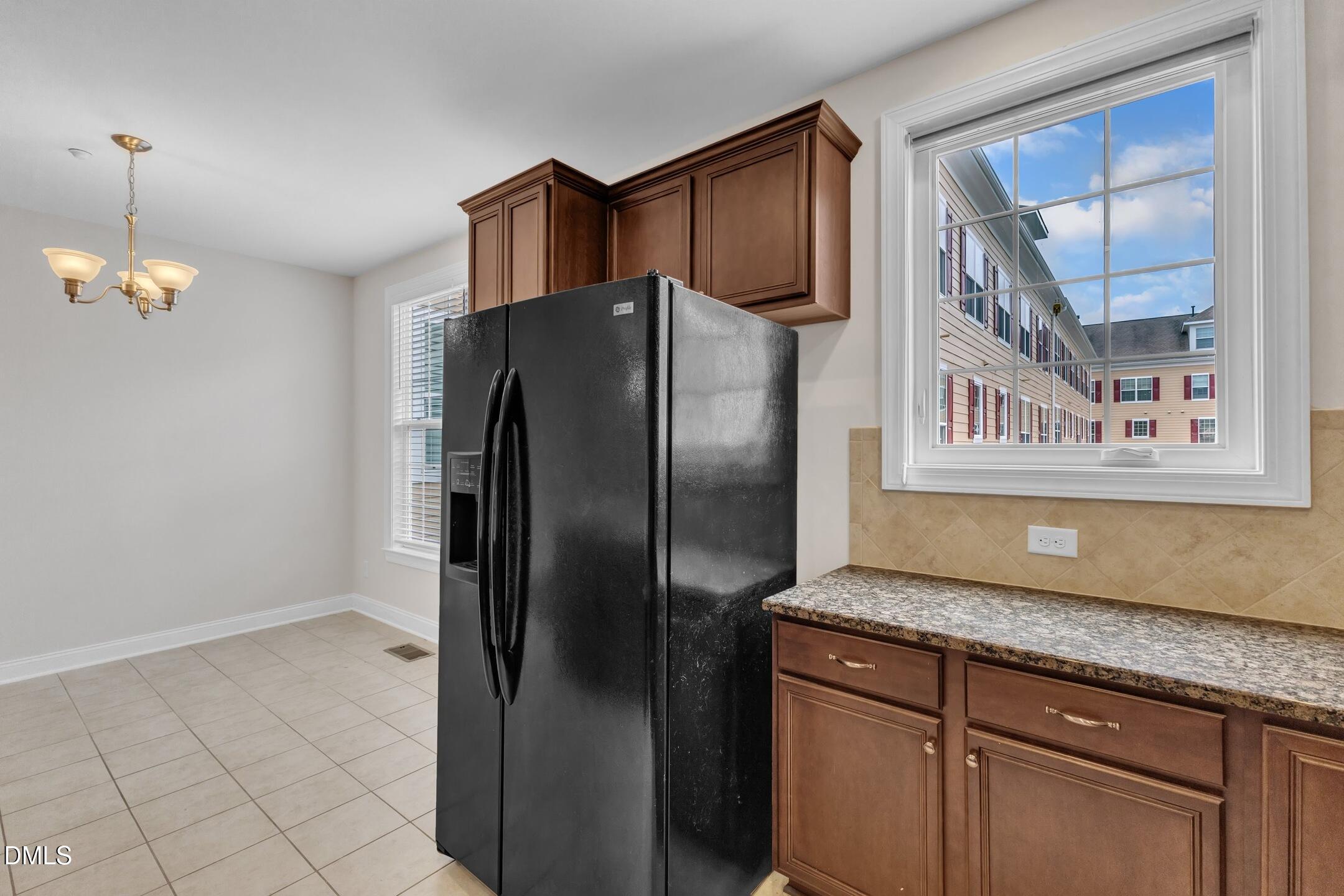 9211 Calabria Drive, Unit 104 Raleigh, NC 27617 - Photo 15 of 45 a kitchen with granite countertop a refrigerator and a sink