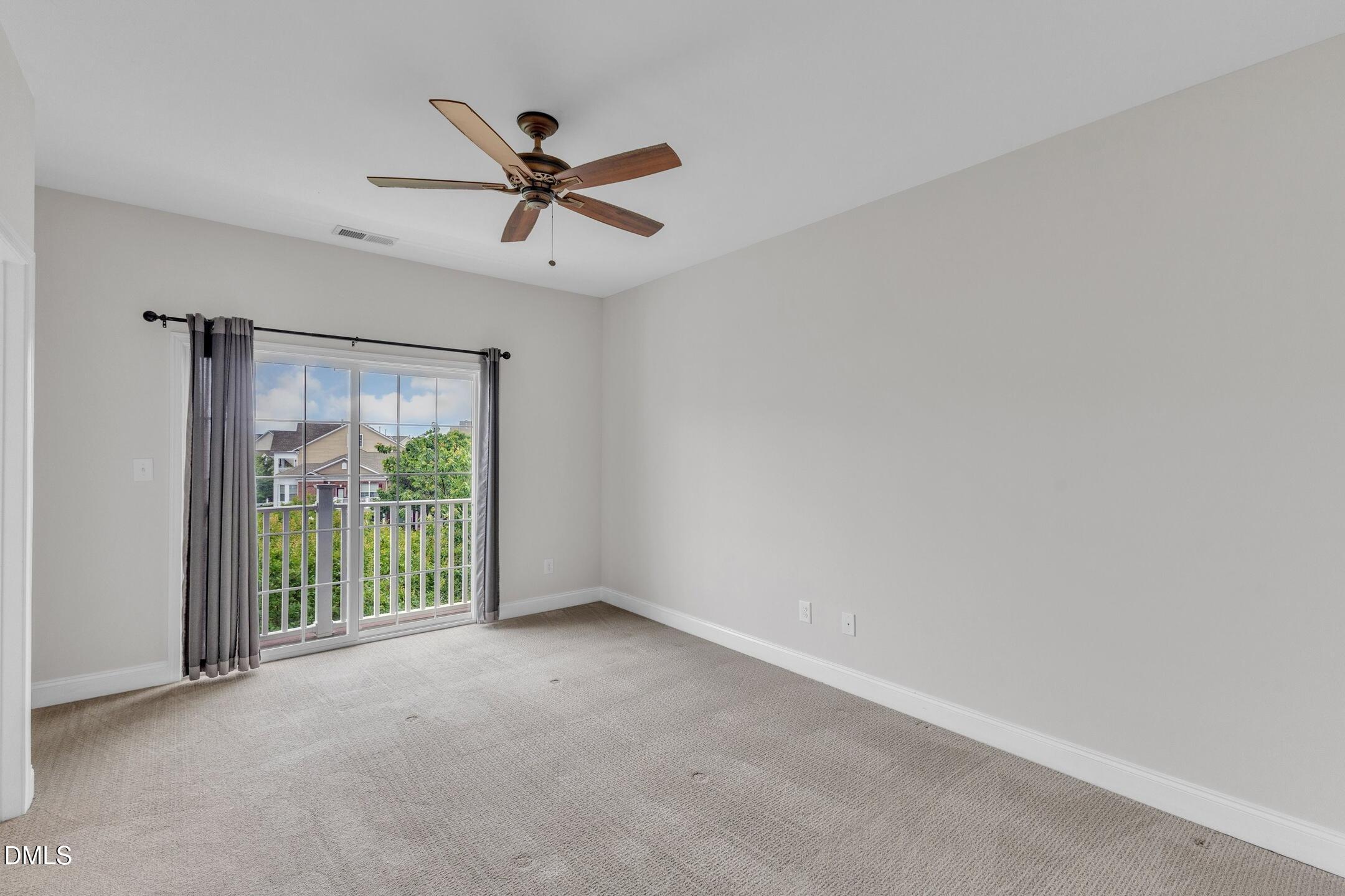 9211 Calabria Drive, Unit 104 Raleigh, NC 27617 - Photo 22 of 45 a view of a livingroom with a ceiling fan and window