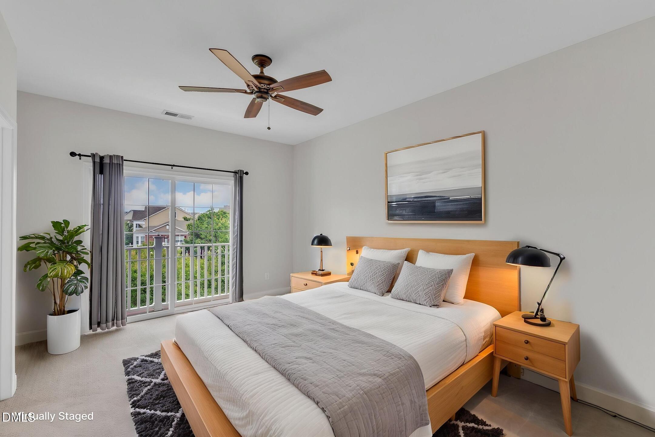 9211 Calabria Drive, Unit 104 Raleigh, NC 27617 - Photo 23 of 45 a bedroom with a bed and a large window