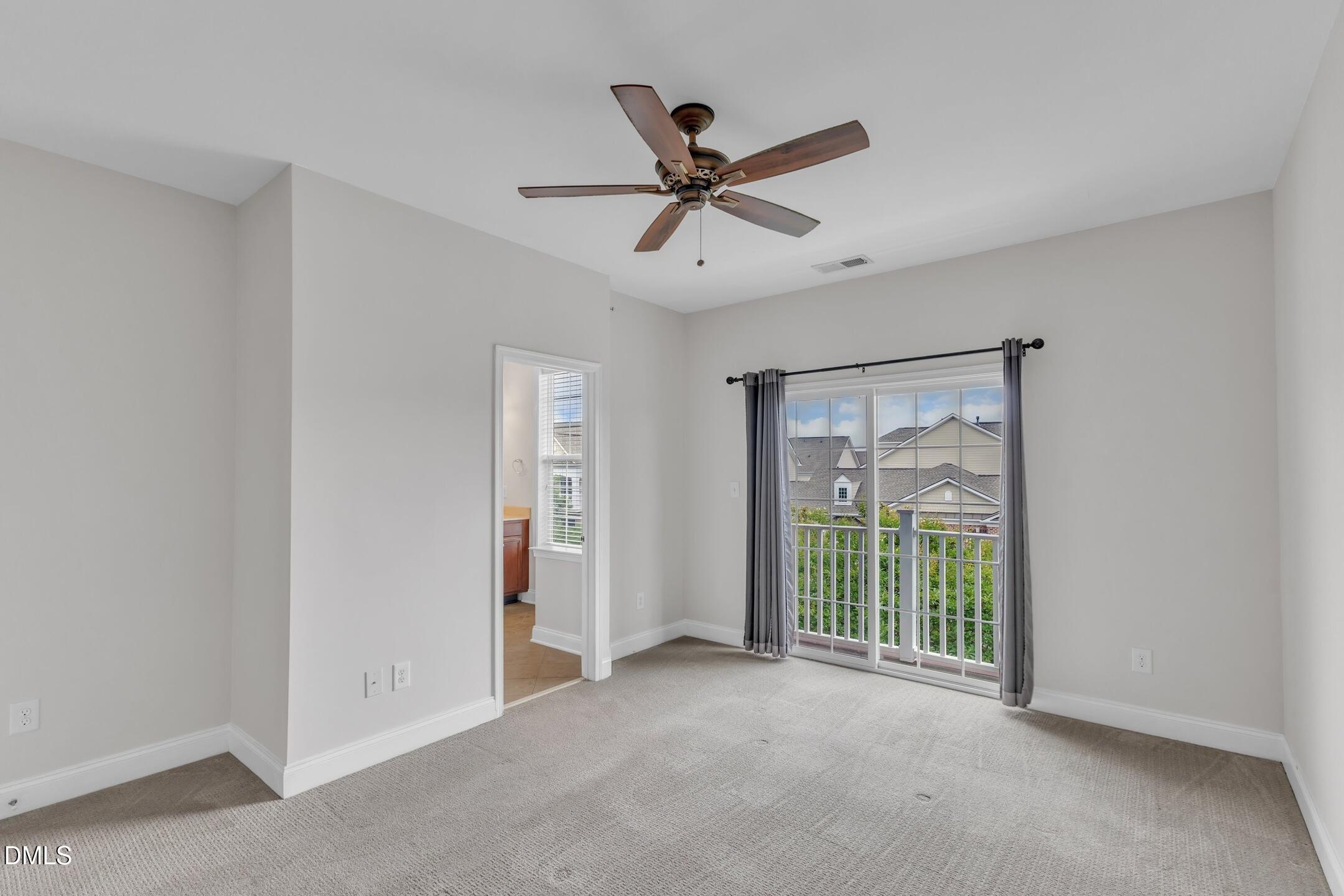 9211 Calabria Drive, Unit 104 Raleigh, NC 27617 - Photo 24 of 45 a view of a livingroom with a ceiling fan & windows