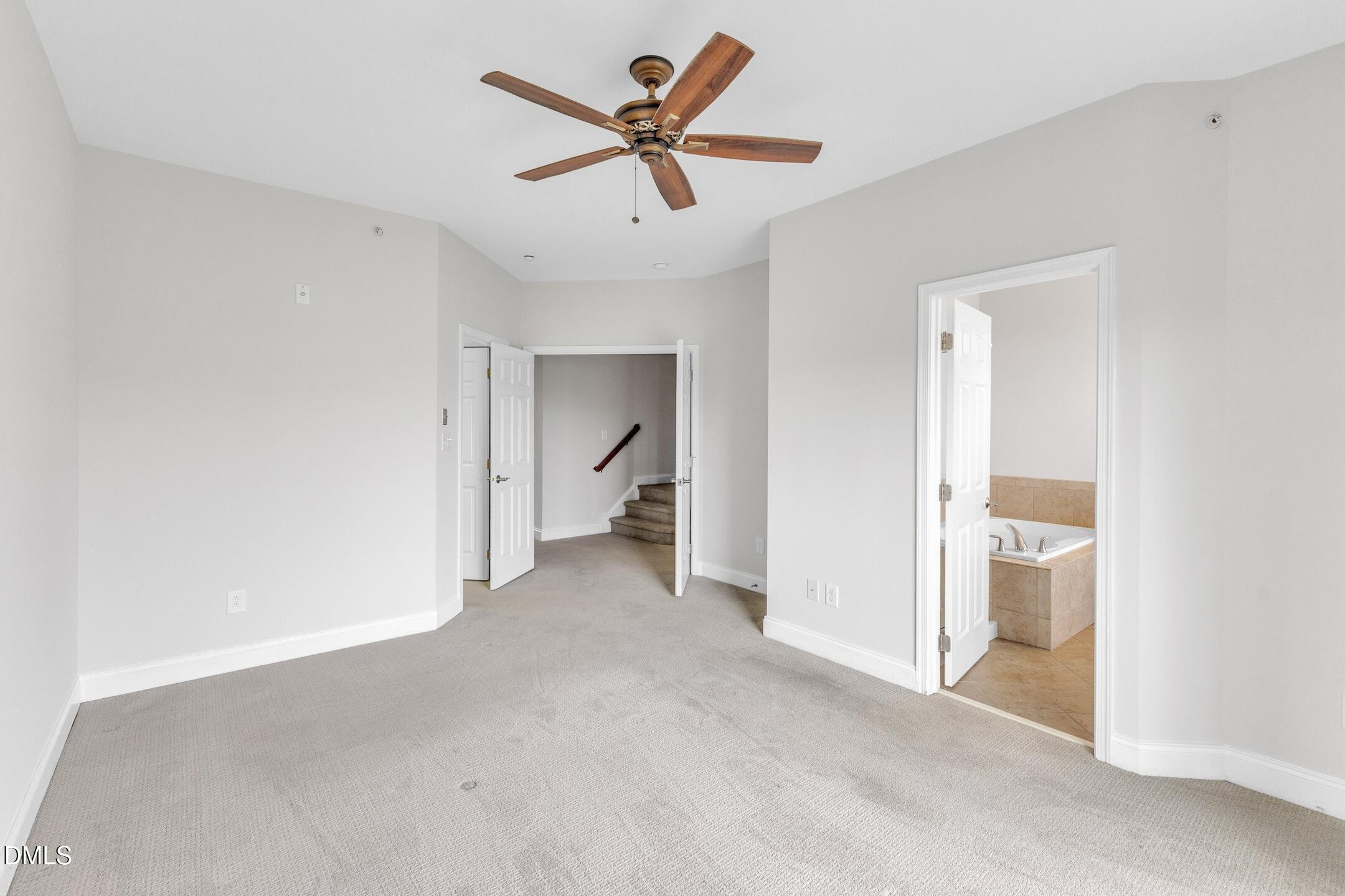 9211 Calabria Drive, Unit 104 Raleigh, NC 27617 - Photo 25 of 45 a view of a room with a ceiling fan and a bathroom