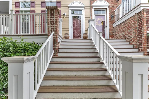 a view of staircase with wooden floor and a large window