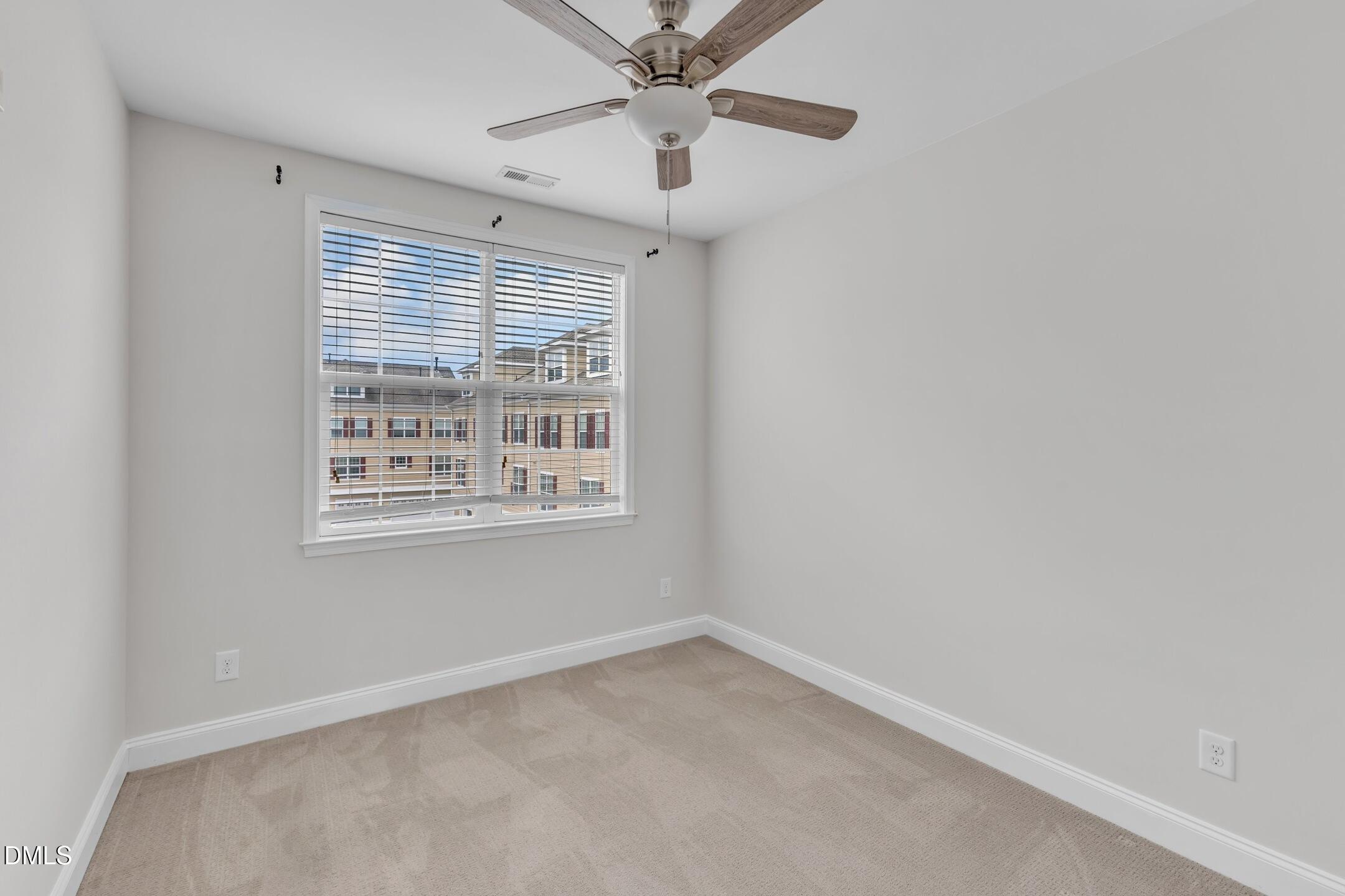 9211 Calabria Drive, Unit 104 Raleigh, NC 27617 - Photo 35 of 45 an empty room with a window and a fan