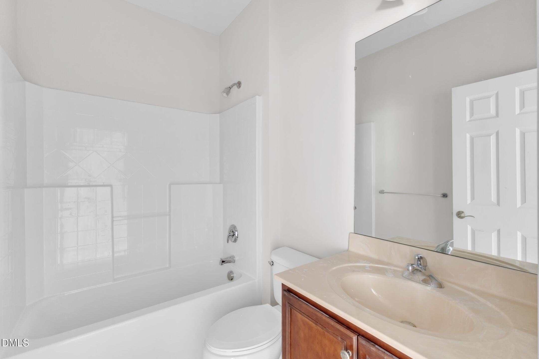 9211 Calabria Drive, Unit 104 Raleigh, NC 27617 - Photo 37 of 45 a bathroom with a granite countertop sink toilet and shower