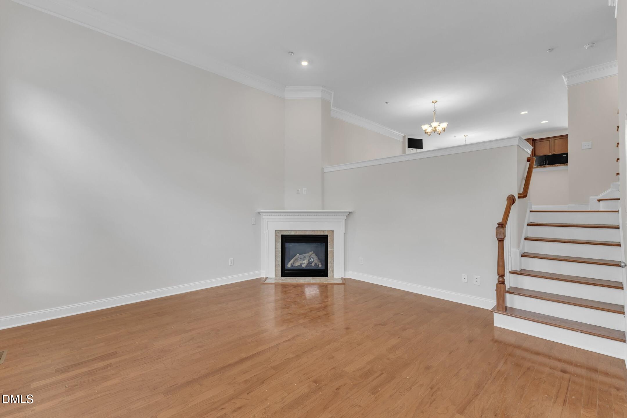 9211 Calabria Drive, Unit 104 Raleigh, NC 27617 - Photo 5 of 45 a view of a livingroom with wooden floor and a fireplace