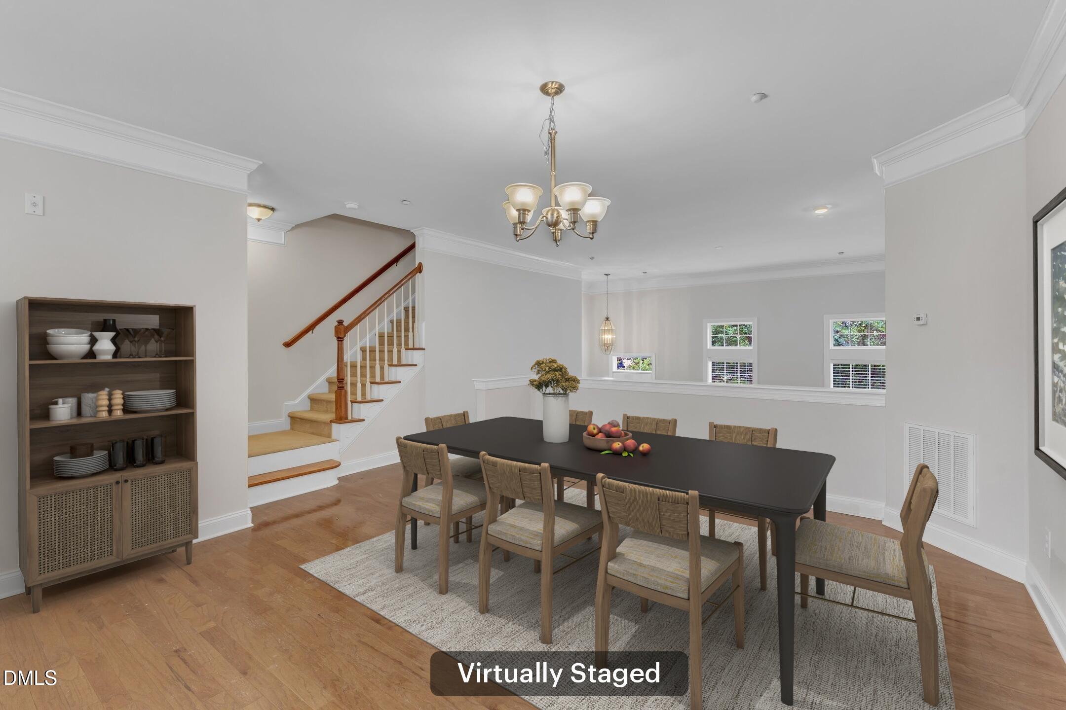 9211 Calabria Drive, Unit 104 Raleigh, NC 27617 - Photo 9 of 45 a view of a dining room with furniture and wooden floor