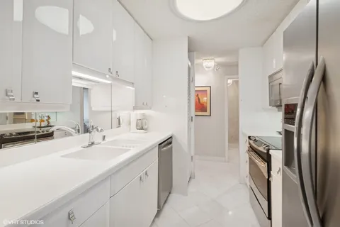 a kitchen with a sink stainless steel appliances and cabinets