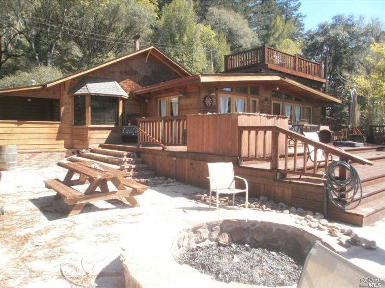 a front view of a house with a yard outdoor seating and barbeque oven