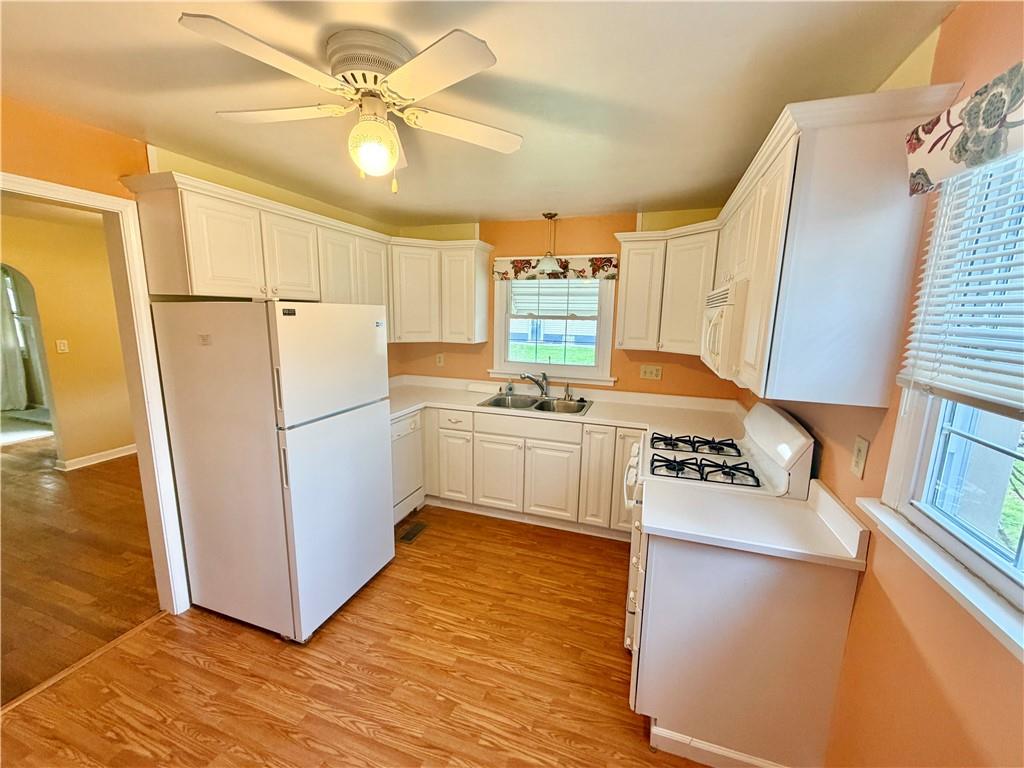 35 Cramer Avenue Uniontown, PA 15401 - Photo 20 of 21 a kitchen with a sink a refrigerator a stove a microwave and cabinets