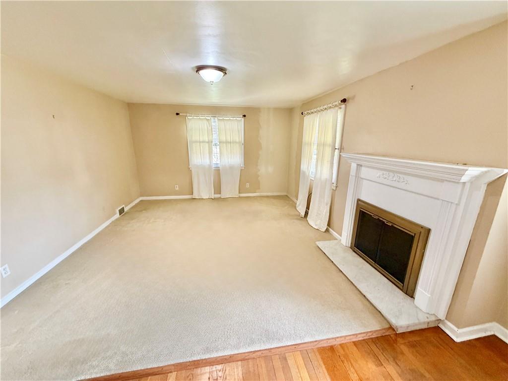 35 Cramer Avenue Uniontown, PA 15401 - Photo 8 of 21 a view of empty room with a fireplace and wooden floor