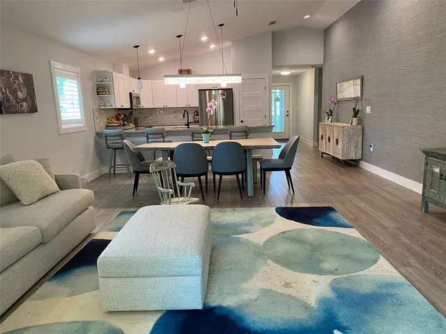 a living room with furniture and a dining table