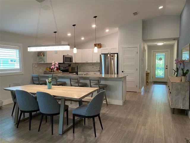 a large kitchen with a table and chairs