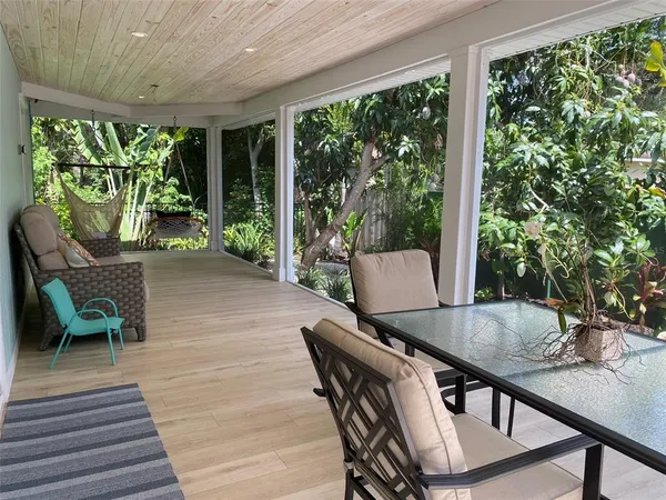 a outdoor dining space with furniture and garden view