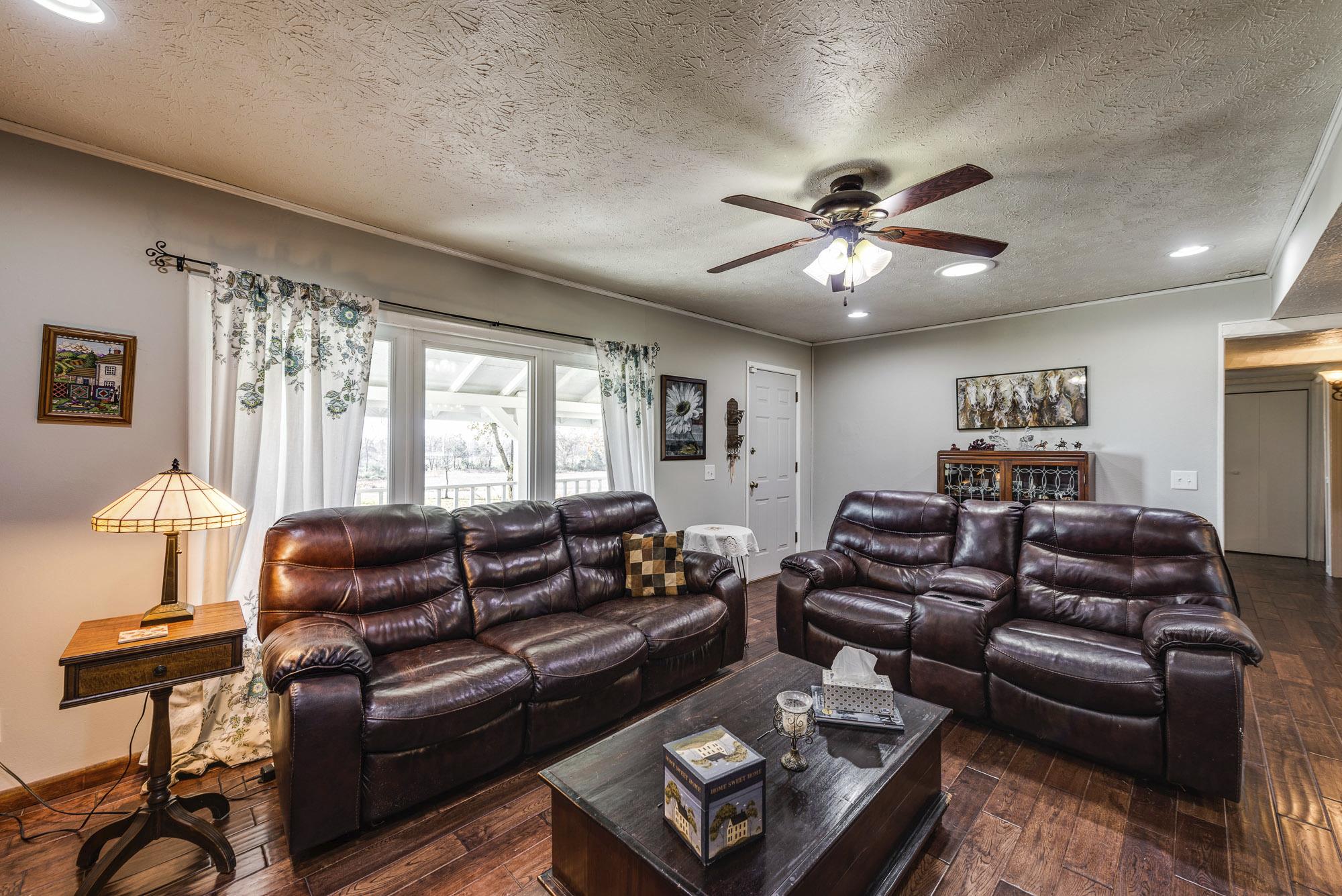7451 Martin Road Baxter, TN 38544 - Photo 11 of 29 a living room with furniture ceiling fan and a window