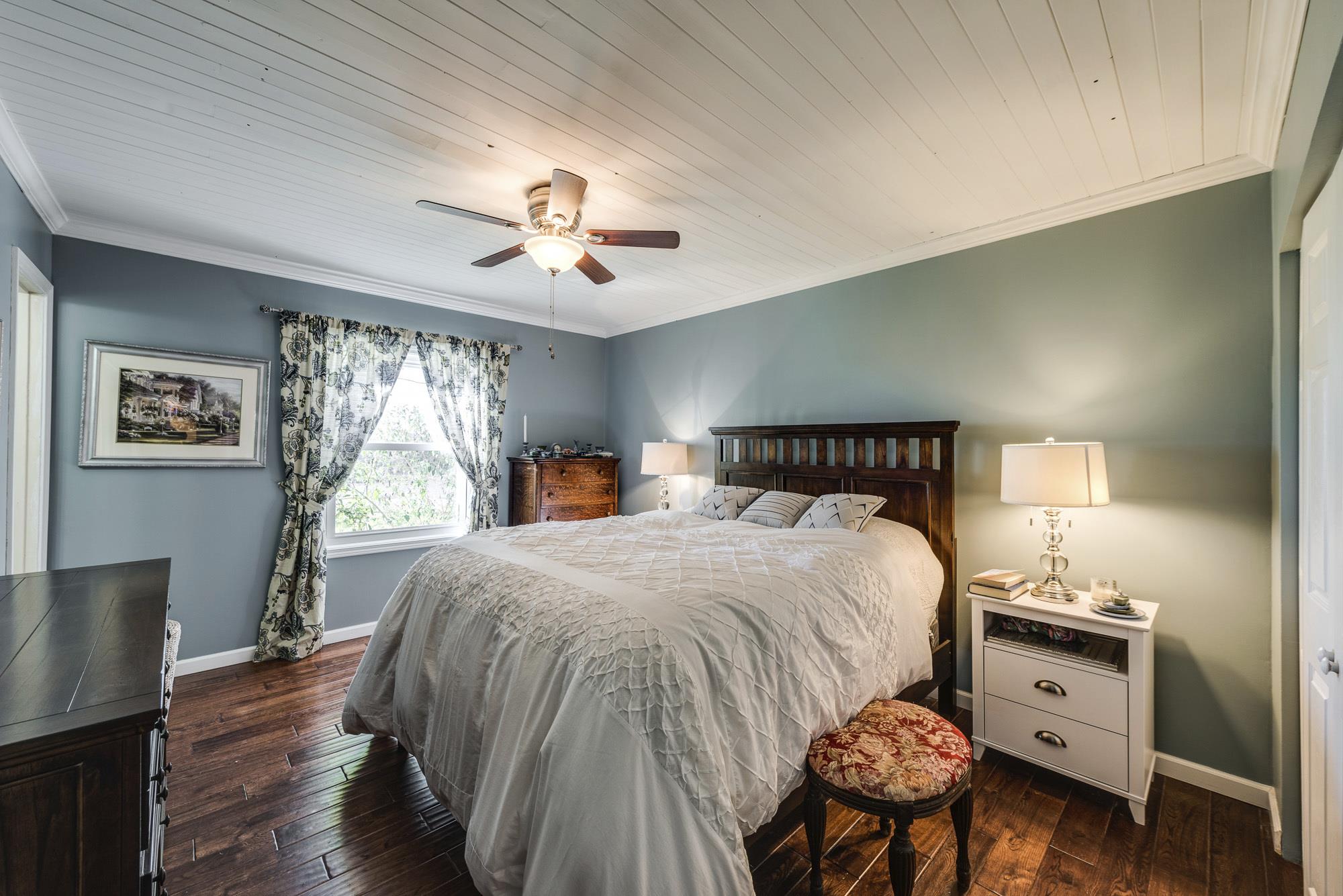 7451 Martin Road Baxter, TN 38544 - Photo 16 of 29 a bedroom with a bed and wooden floor