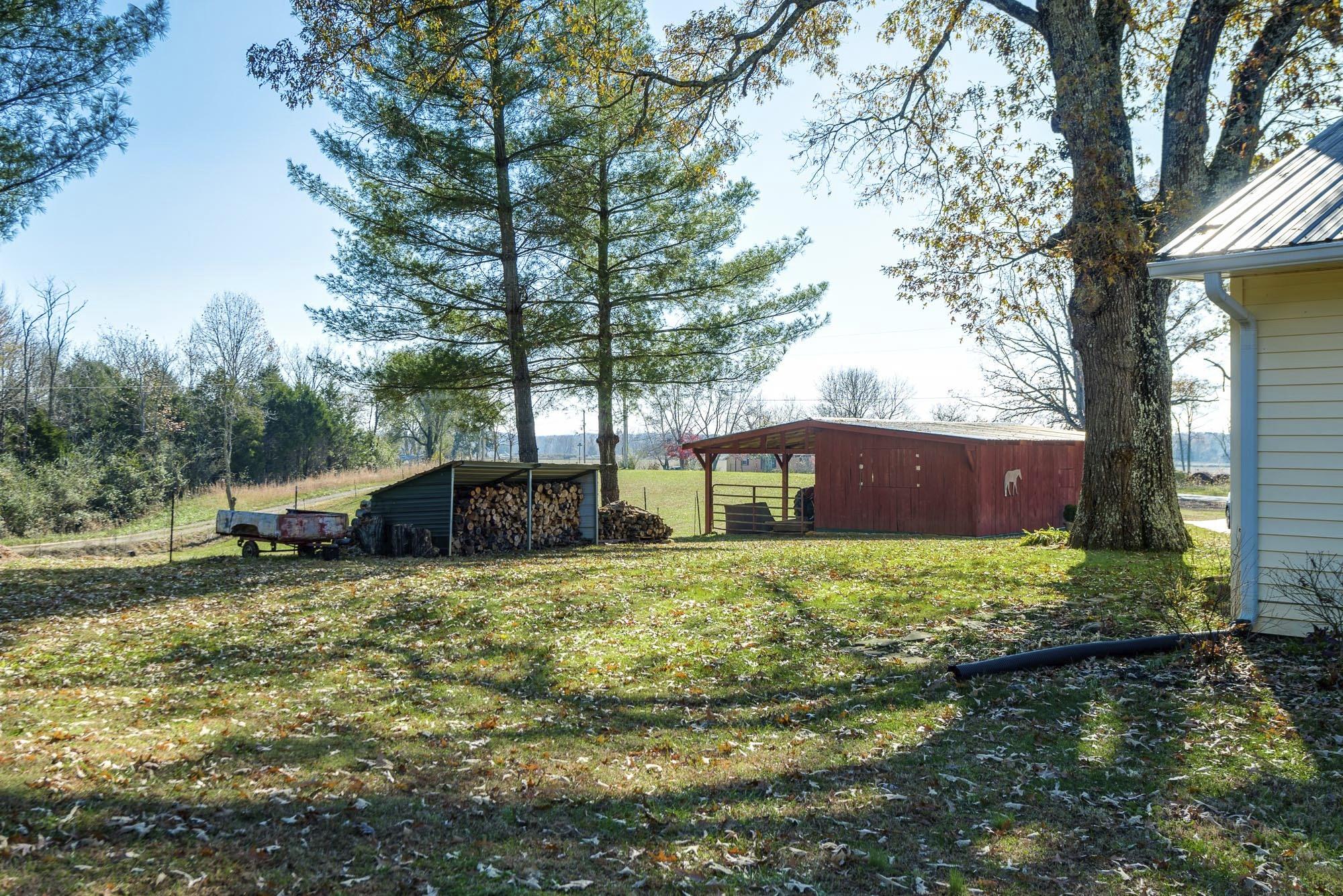 7451 Martin Road Baxter, TN 38544 - Photo 5 of 29 a backyard of a house with yard and trampoline