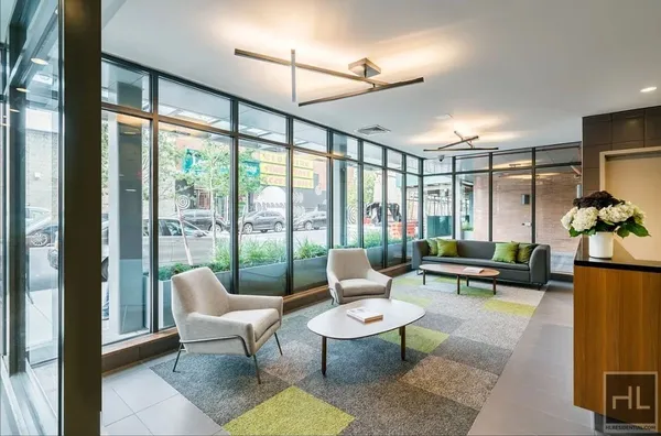 a living room with furniture and floor to ceiling windows