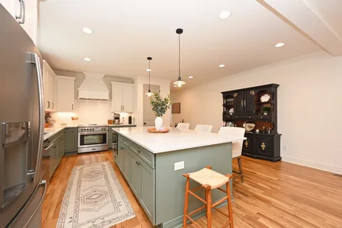 a kitchen with stainless steel appliances a stove and cabinets