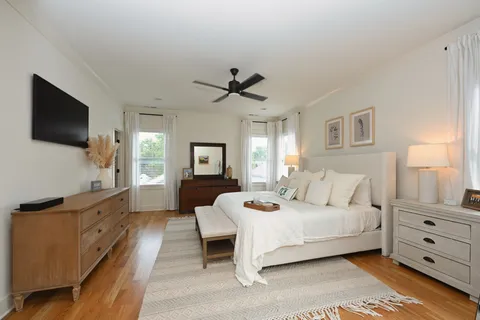 a bedroom with a bed and wooden floor