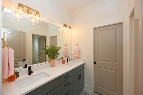 a bedroom with two beds and a desk