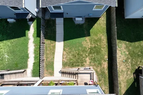 a view of a hallway with wooden floor and workspace