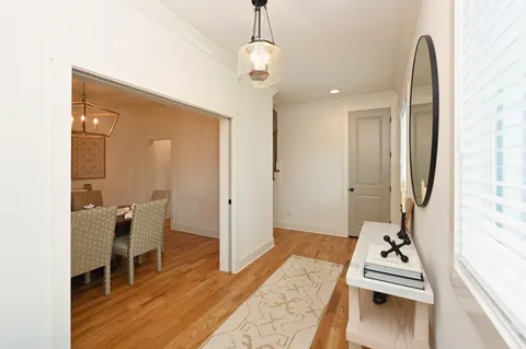 a room with table chair and windows