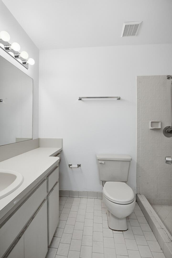 131 Springdale Circle Palm Springs, FL 33461 - Photo 12 of 19 a bathroom with a granite countertop toilet and a sink