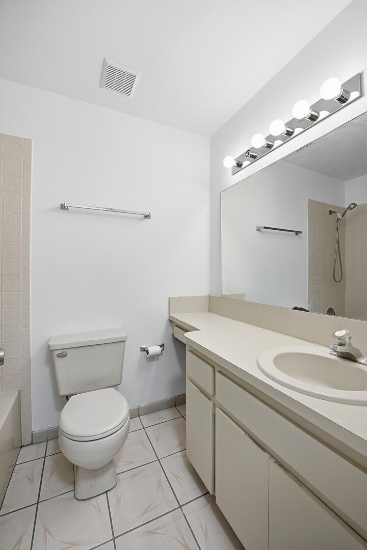 131 Springdale Circle Palm Springs, FL 33461 - Photo 14 of 19 a bathroom with a toilet sink and mirror