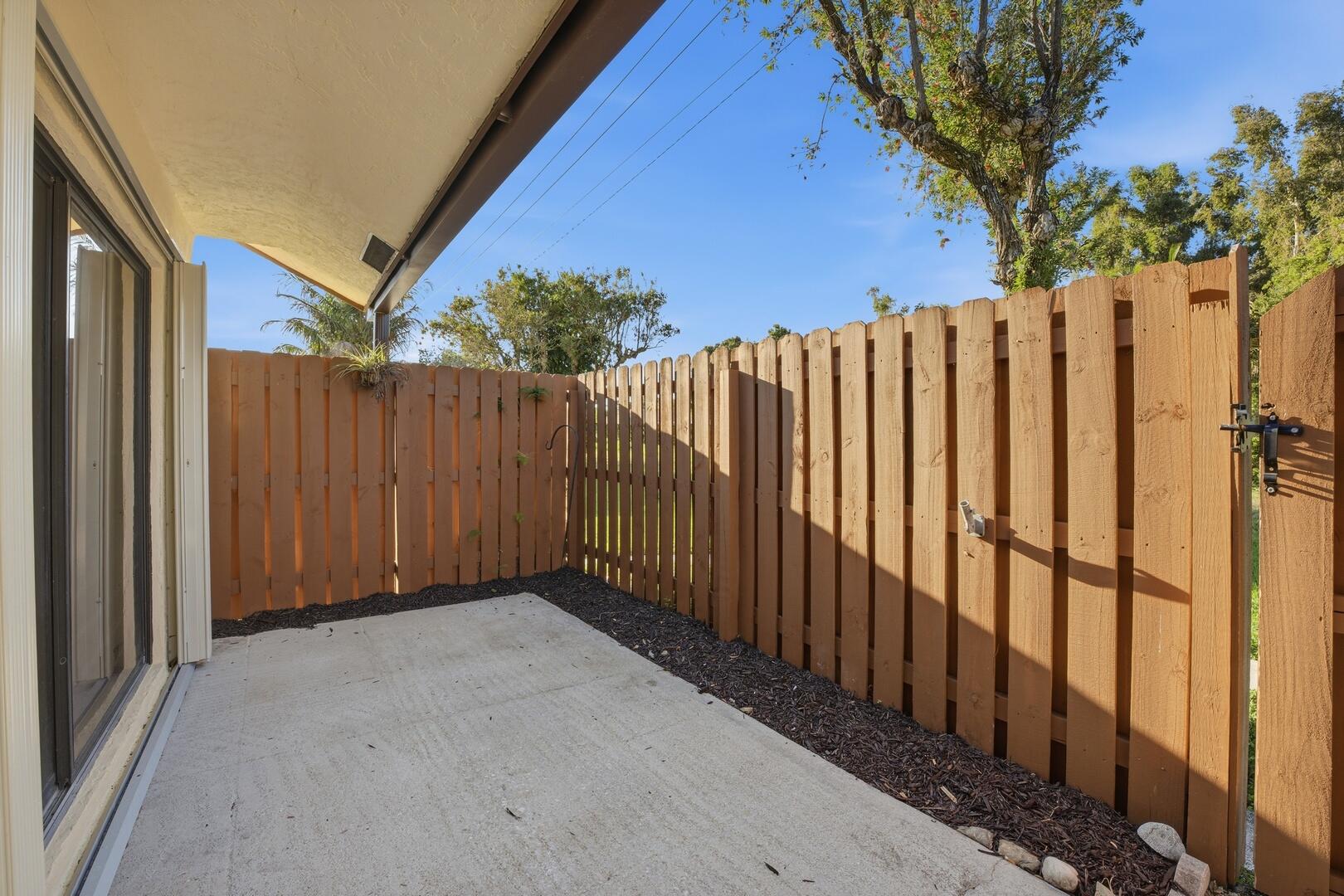 131 Springdale Circle Palm Springs, FL 33461 - Photo 16 of 19 a view of a backyard with wooden fence