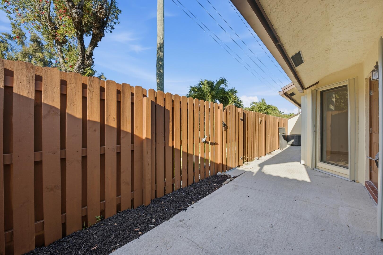 131 Springdale Circle Palm Springs, FL 33461 - Photo 17 of 19 a view of a house with wooden fence