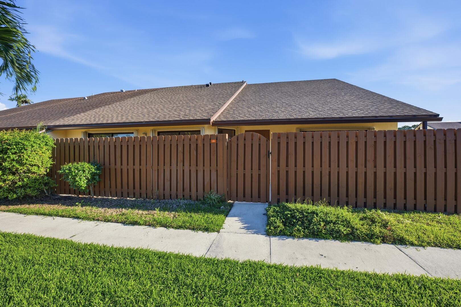 131 Springdale Circle Palm Springs, FL 33461 - Photo 18 of 19 a backyard of a house with lots of green space