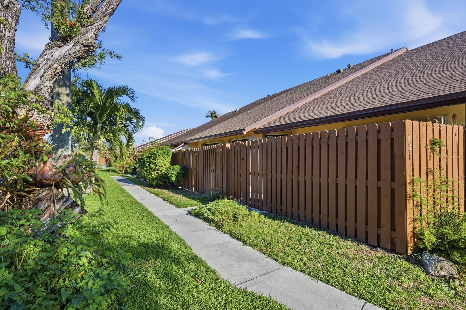 131 Springdale Circle Palm Springs, FL 33461 - Photo 19 of 19 a backyard of a house with lots of green space