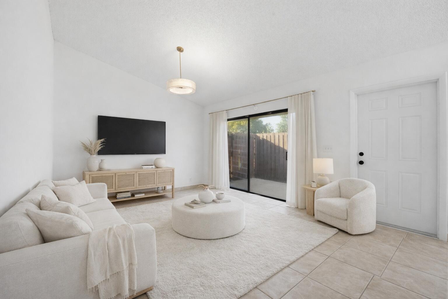 131 Springdale Circle Palm Springs, FL 33461 - Photo 2 of 19 a living room with furniture and a flat screen tv