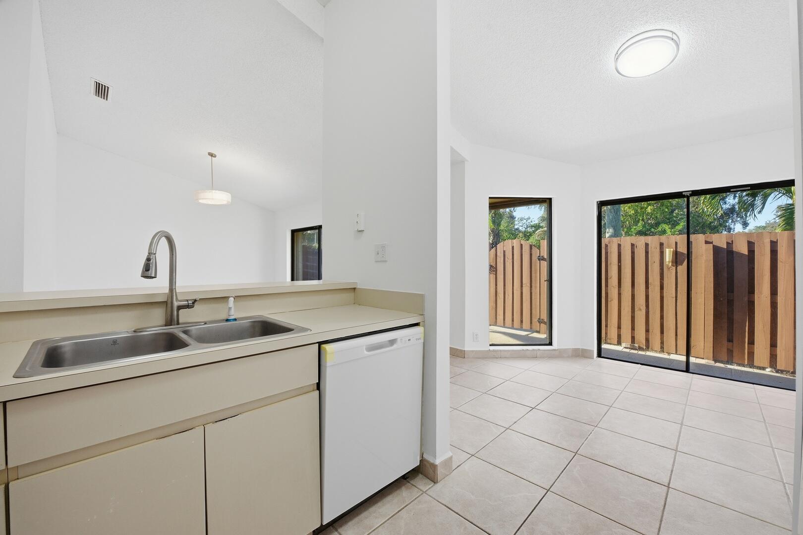131 Springdale Circle Palm Springs, FL 33461 - Photo 6 of 19 a kitchen with a sink and cabinets