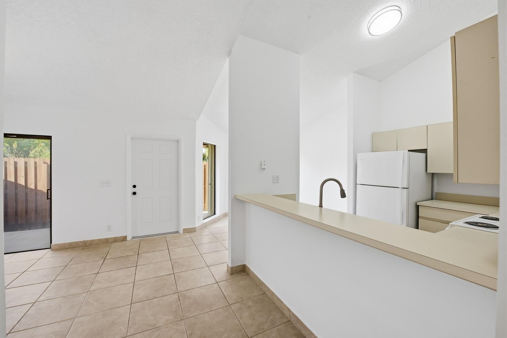 131 Springdale Circle Palm Springs, FL 33461 - Photo 8 of 19 a kitchen with granite countertop a sink and a stove top oven