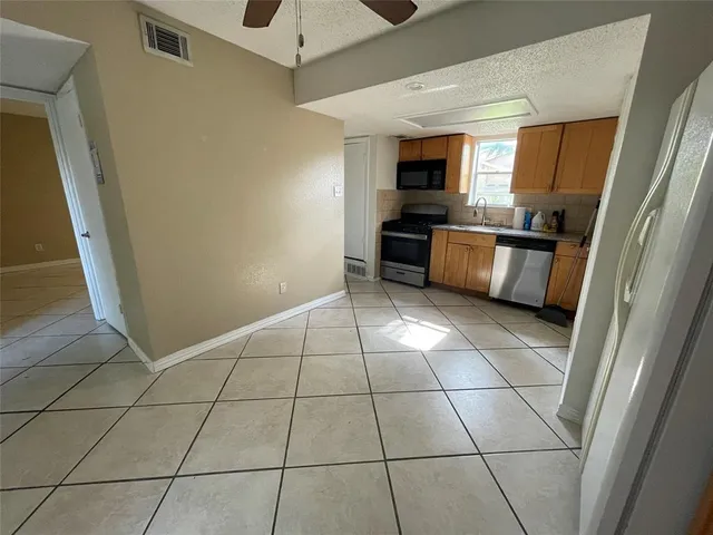 a view of kitchen with furniture and refrigerator