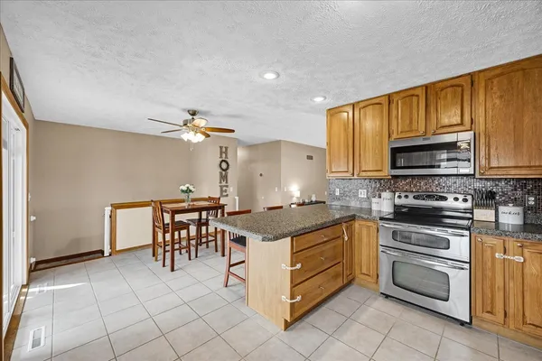 a kitchen with a stove a sink and a microwave