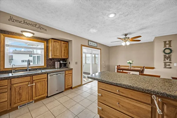 a kitchen with a sink appliances and cabinets