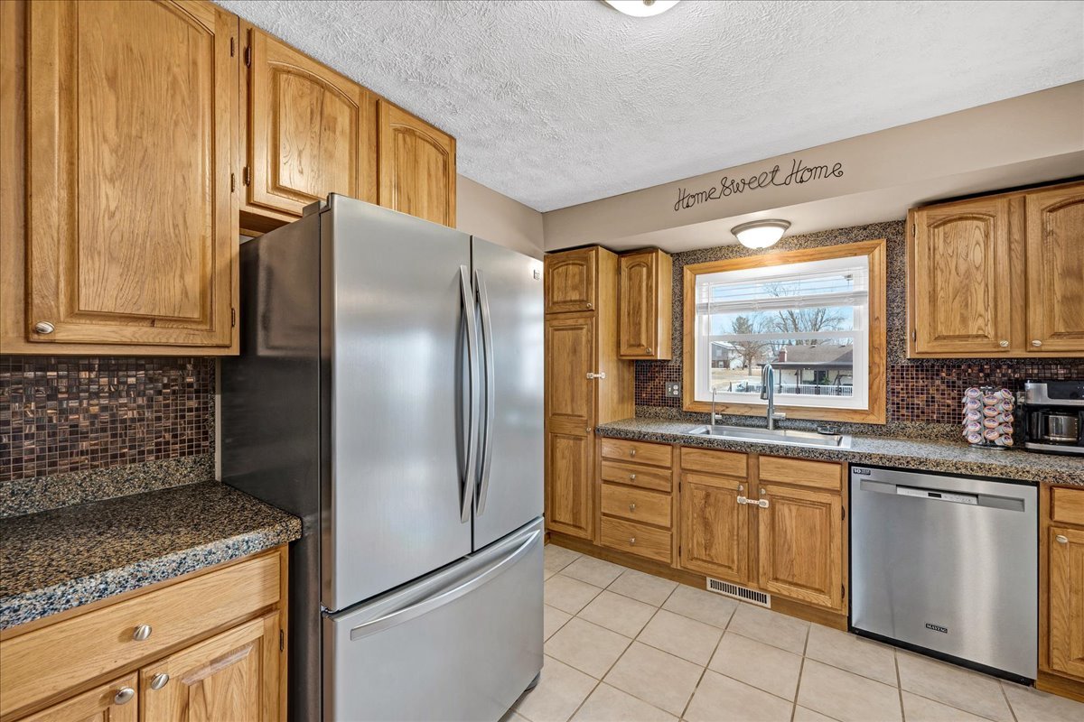 505 West North Street Danvers, IL 61732 - Photo 14 of 45 a kitchen with granite countertop stainless steel appliances a refrigerator stove top oven and sink