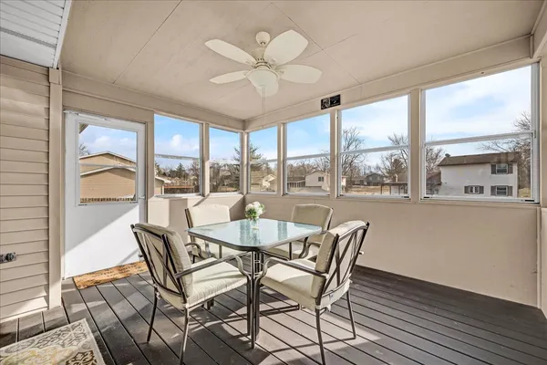 a dining room with furniture large windows and a chandelier