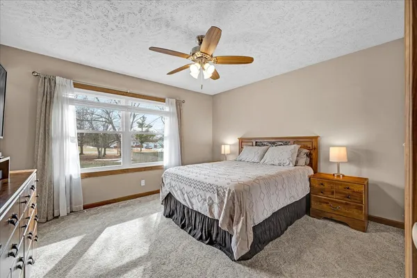 a bedroom with a bed and a chandelier