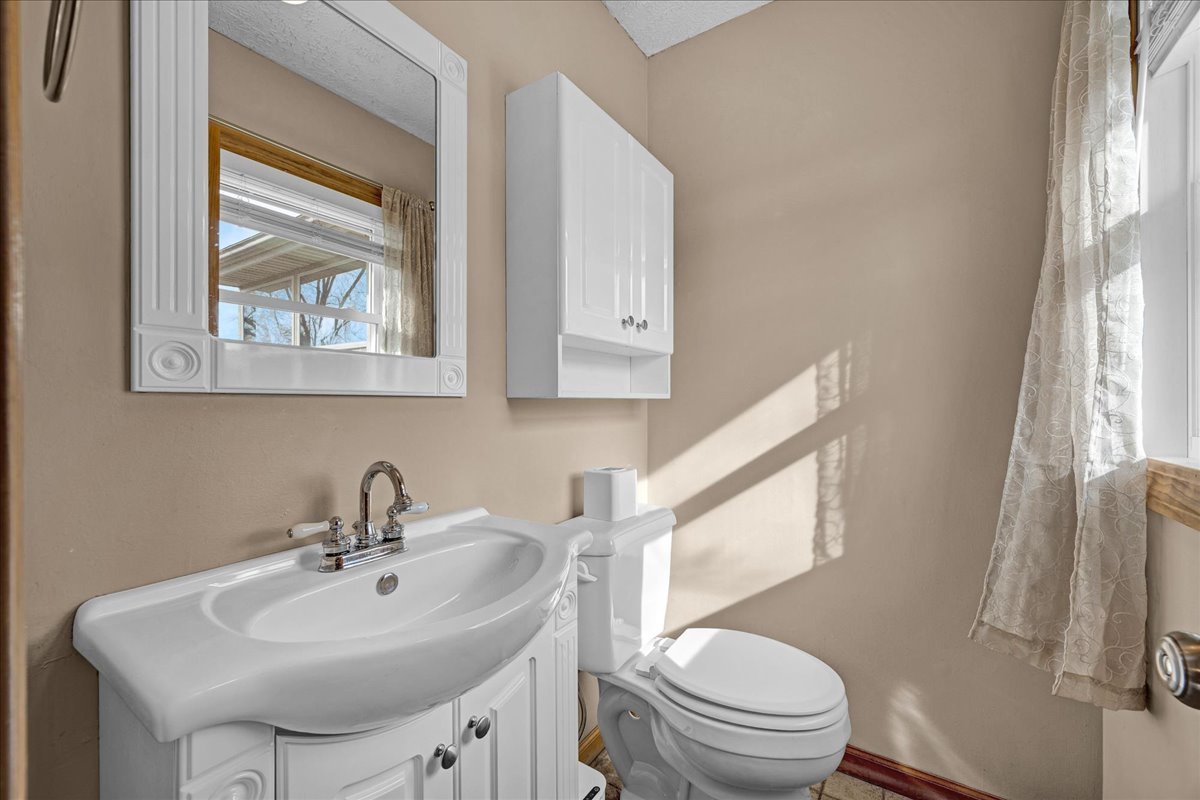 505 West North Street Danvers, IL 61732 - Photo 18 of 45 a bathroom with a sink a toilet and a window