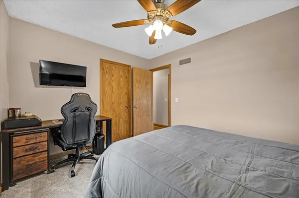 a bedroom with a bed and a chandelier