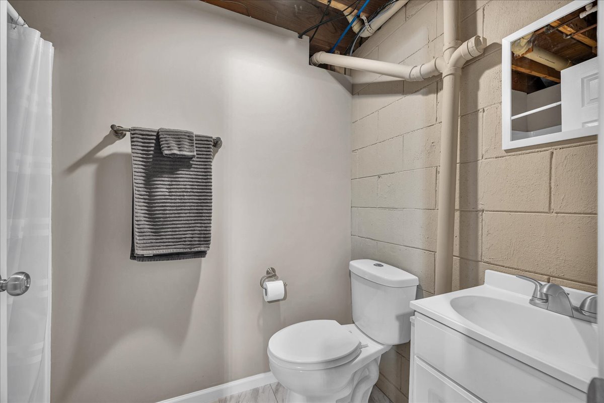 505 West North Street Danvers, IL 61732 - Photo 29 of 45 a bathroom with a toilet sink vanity and shower