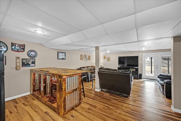 a living room with furniture flat screen tv and wooden floor
