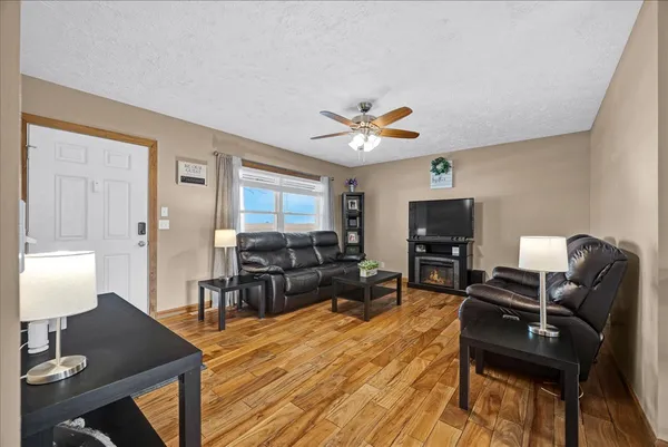 a living room with furniture a dining table and a fireplace