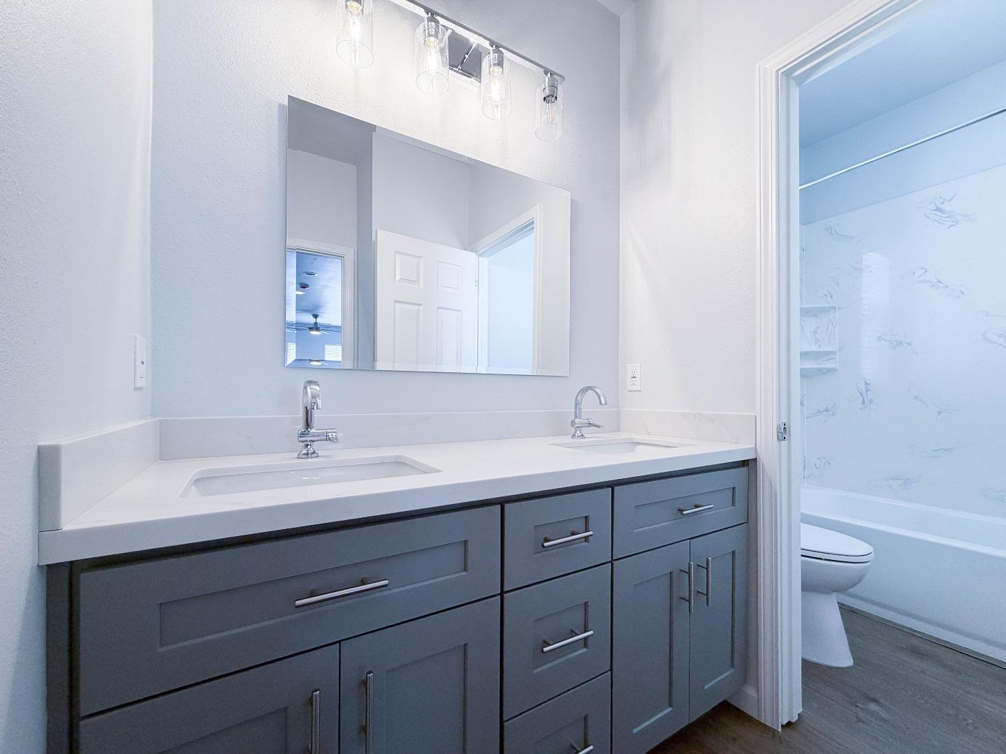 2715 Shellgate Circle Hayward, CA 94545 - Photo 32 of 47 a bathroom with a granite countertop sink a toilet and a bathtub